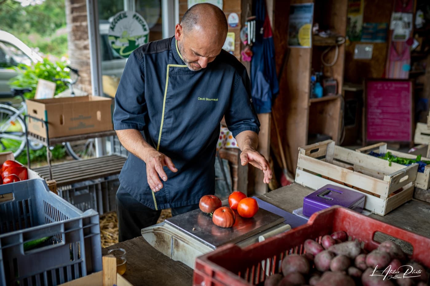 Chef David Bourmaud weighing tomatoes at a local producer